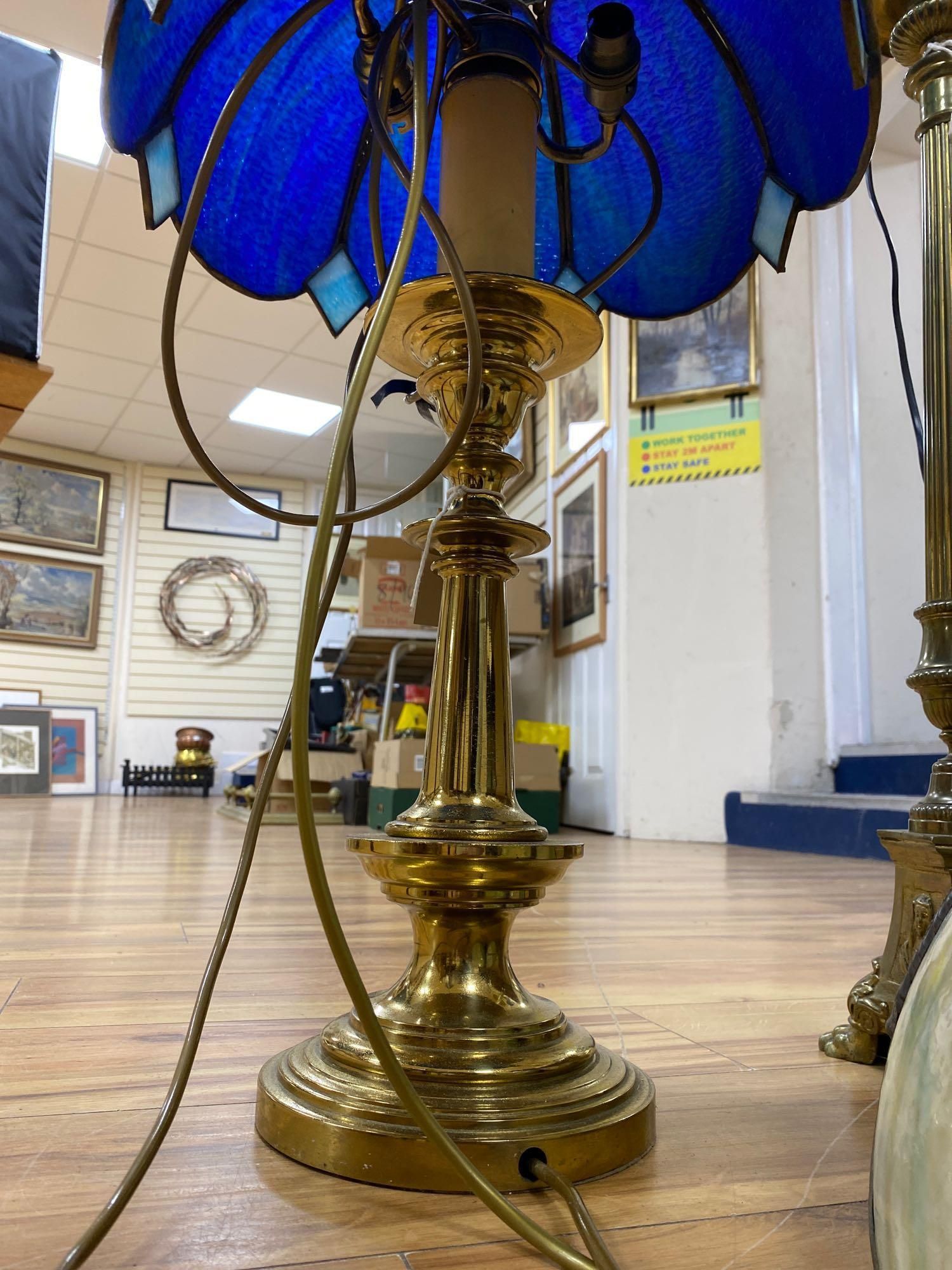 A brass column lamp and a brass standard lamp on three paw feet (with shades)